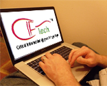 `A man using a laptop with a IT company logo